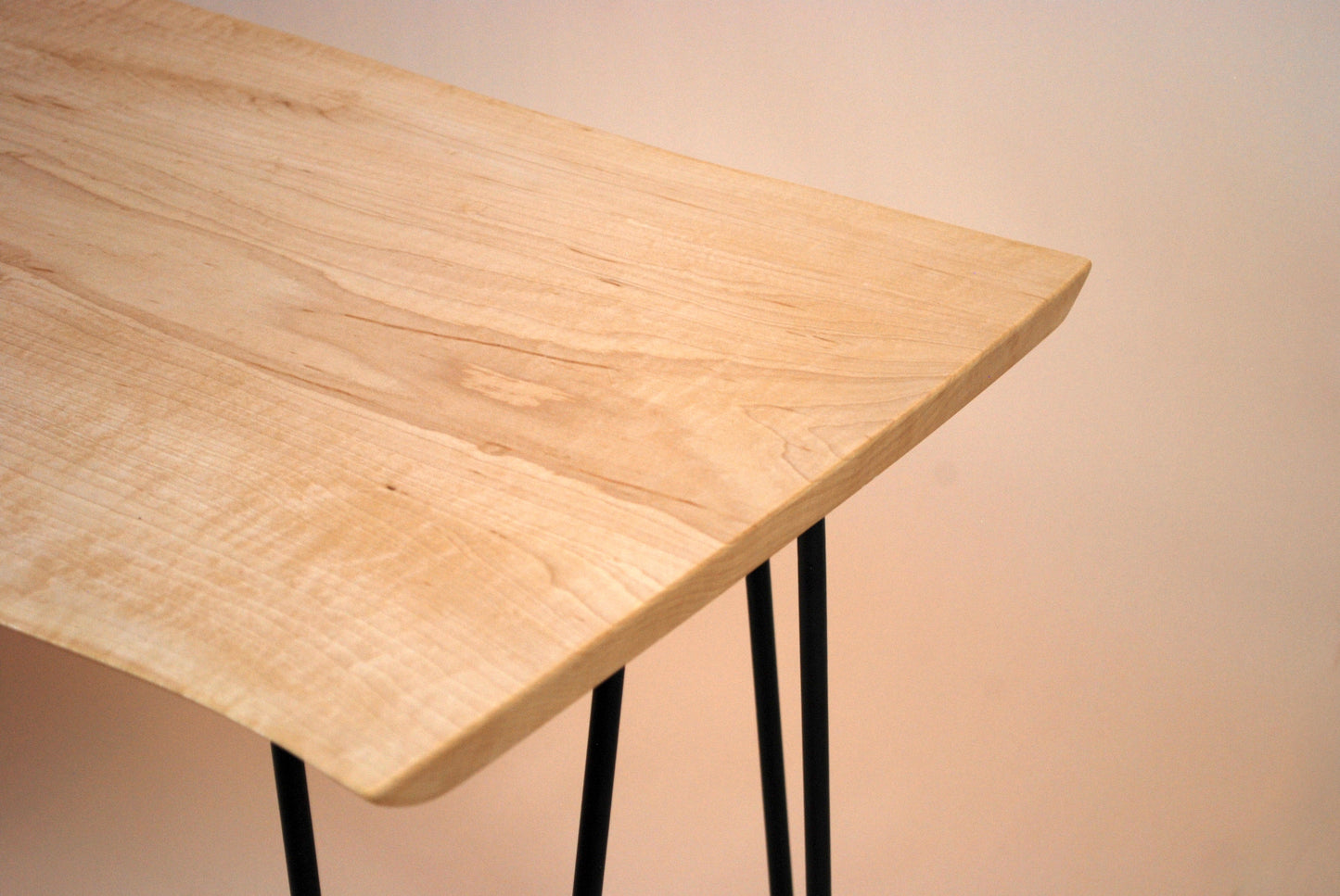 Figured maple coffee table with inset beach stones and hairpin legs