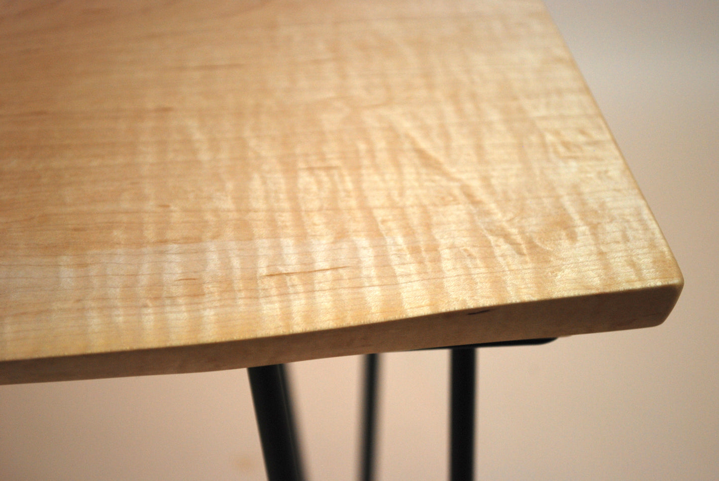 Figured maple coffee table with inset beach stones and hairpin legs