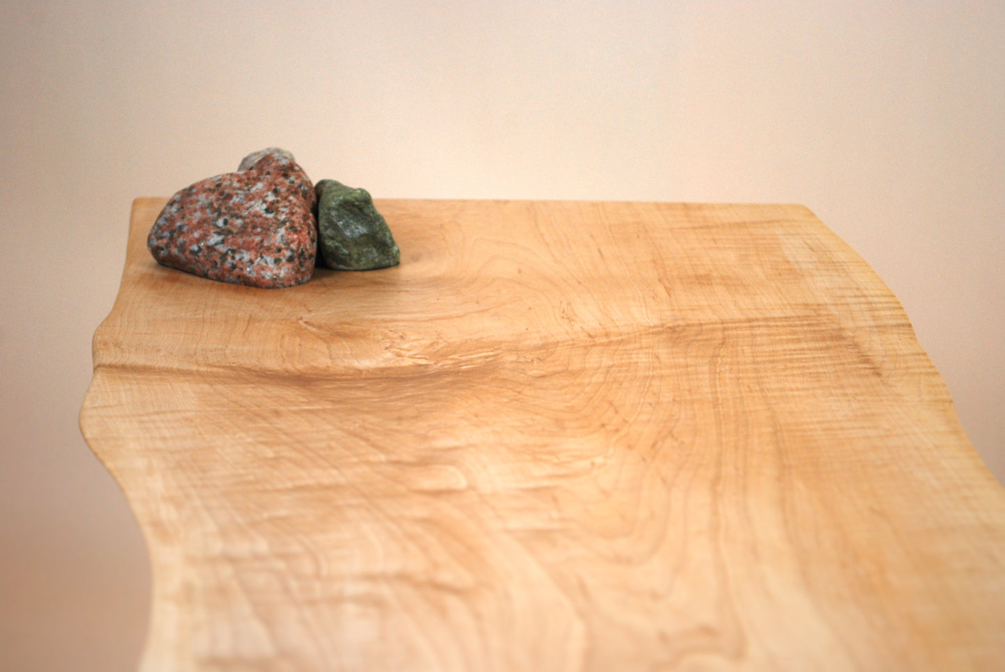 Figured maple coffee table with inset beach stones and hairpin legs